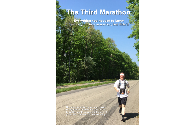 The DRAFT front cover of the book The Third Marathon which Paul plans to publish late in 2024 - a photo of a very sunny day on a road in rural France - Paul is wearing his Geneva Marathon runners bib and his regular running kit