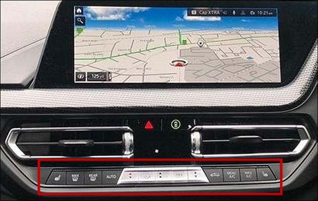 part of a 2023 BMW dashboard showing a touch screen computer above a group of small light-touch rocker switches (with very small writing and icons) for controlling ventilation